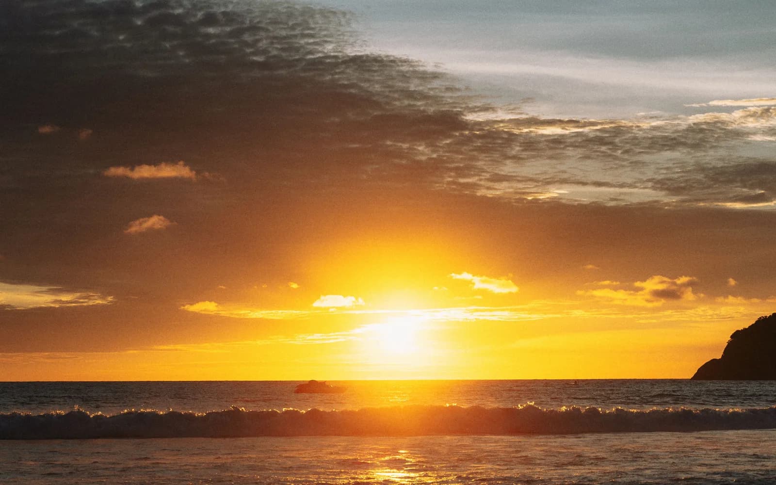 Sunset over Kata Beach in Phuket, with golden light on the water