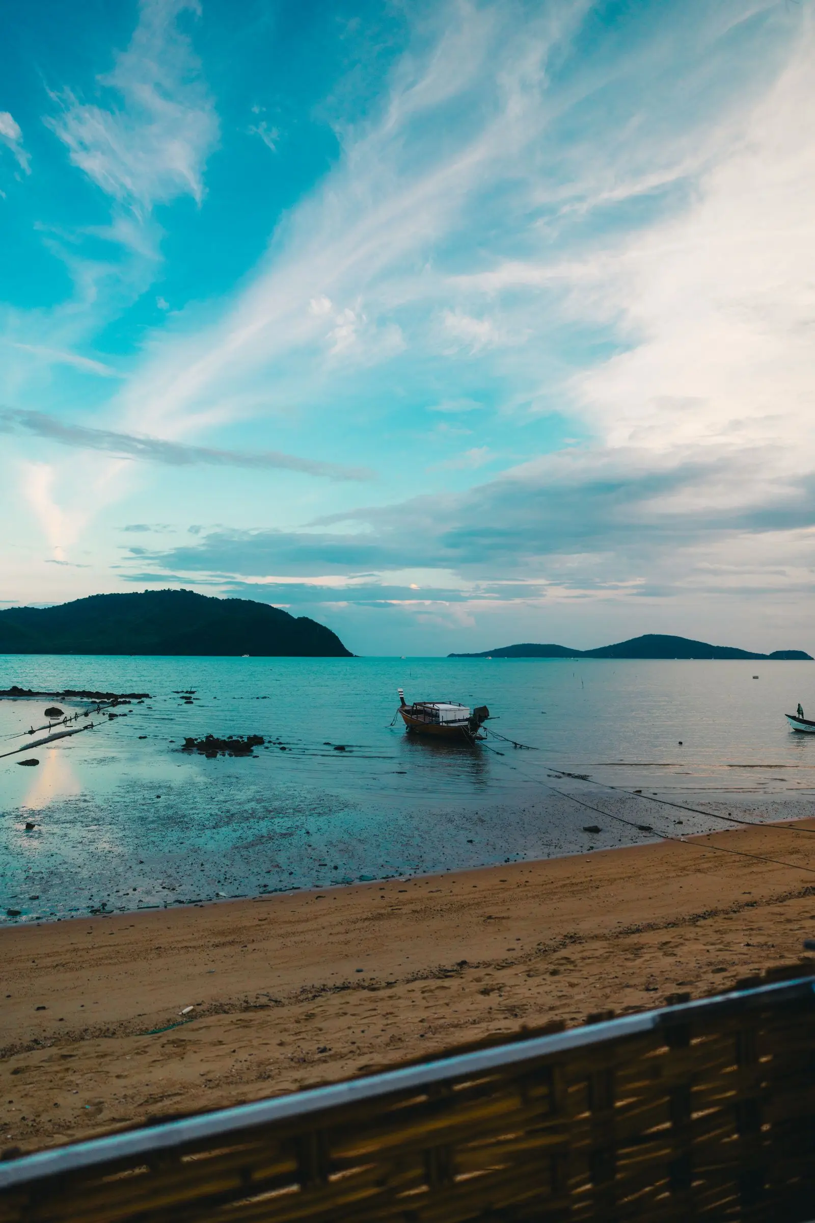 Beachfront view with boats and islands in Phuket, Thailand