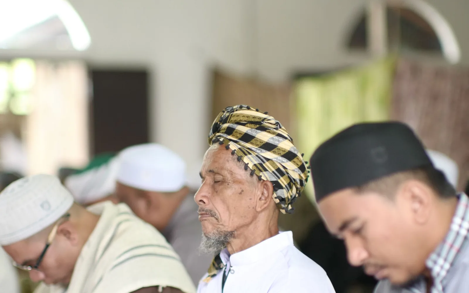 Men at prayer inside a mosque in Muno, Thailand