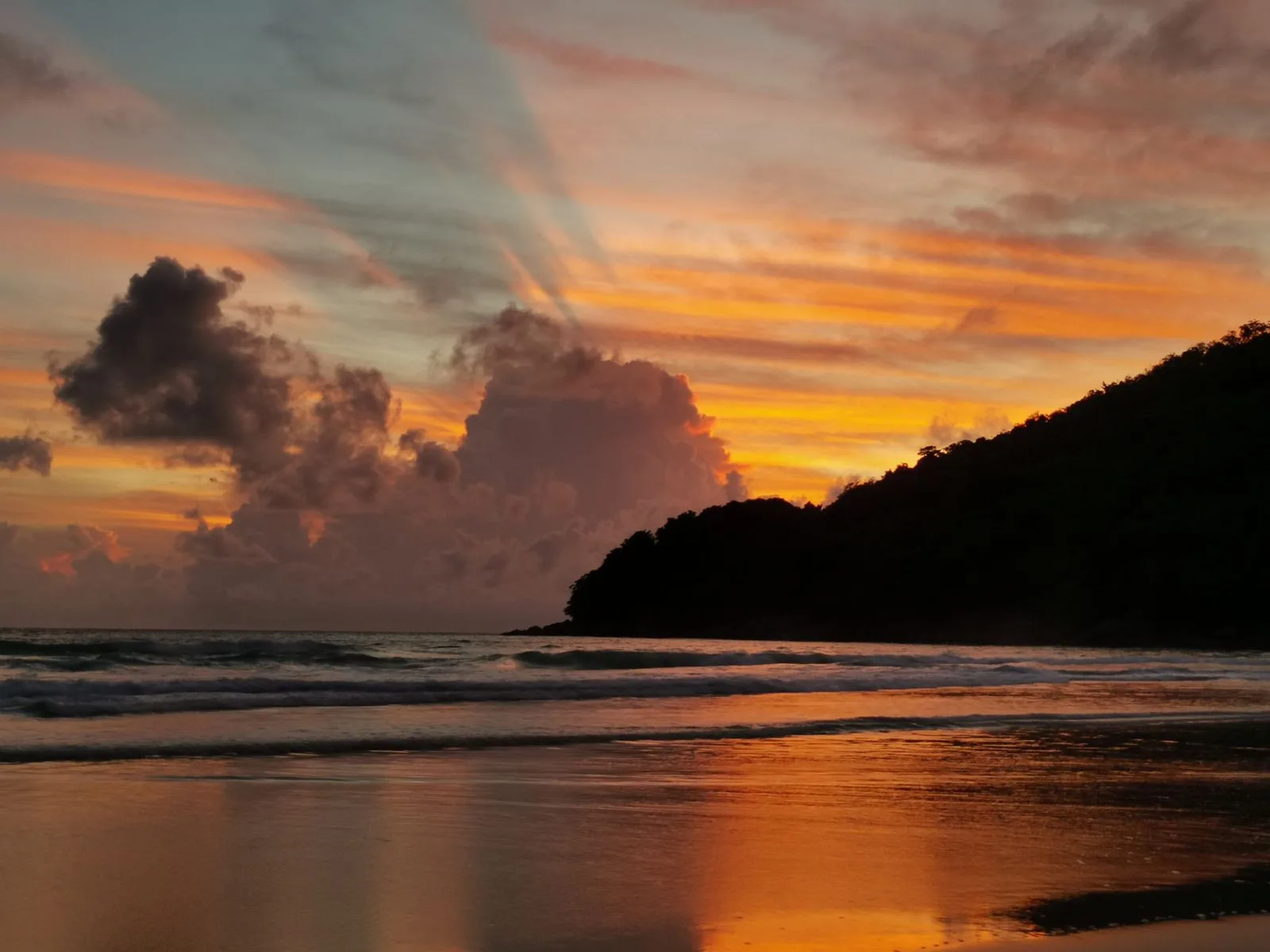Sun dropping towards the sea at a beach